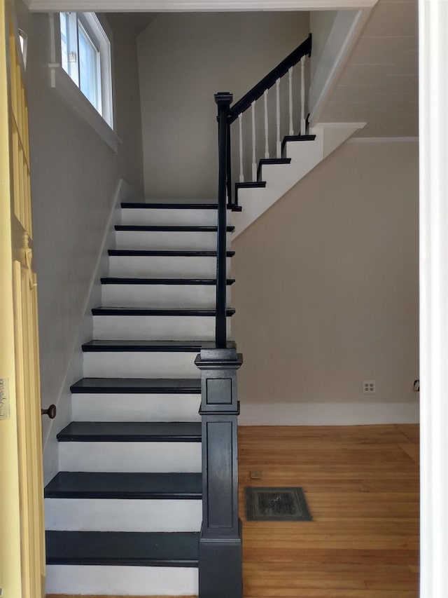 stairs featuring baseboards and wood finished floors
