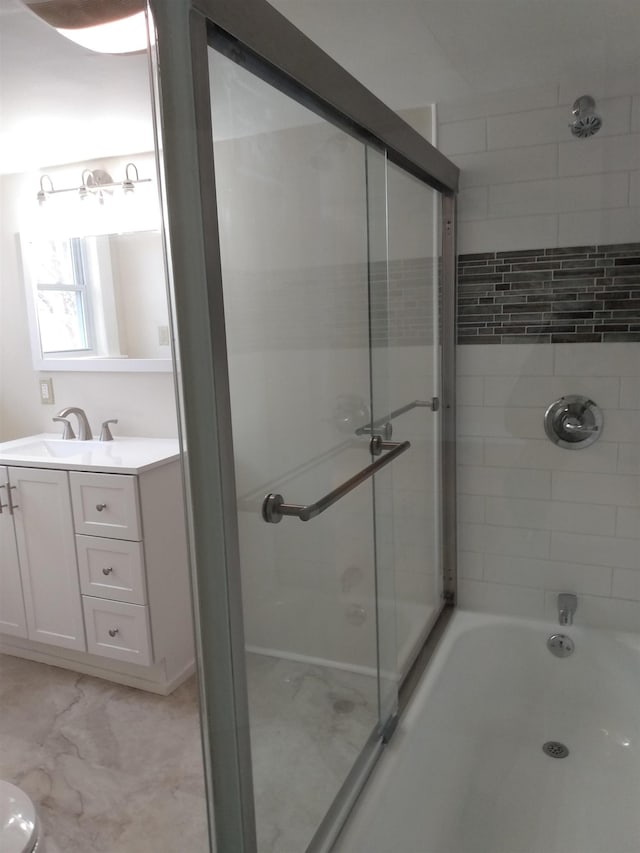 full bathroom with enclosed tub / shower combo and vanity