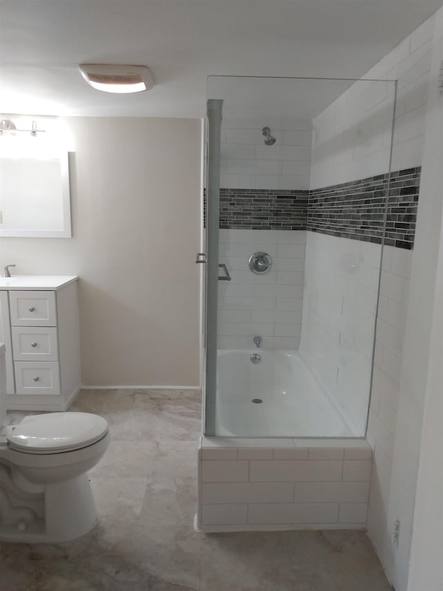 bathroom featuring tiled shower / bath combo, toilet, baseboards, and vanity
