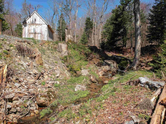 view of yard featuring a barn and an outdoor structure