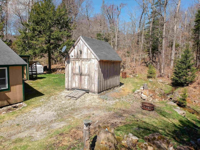 view of shed with a fire pit