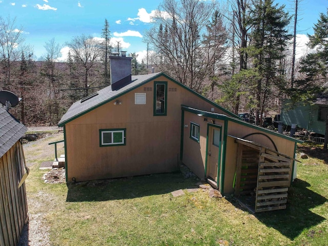 exterior space featuring a yard and a chimney