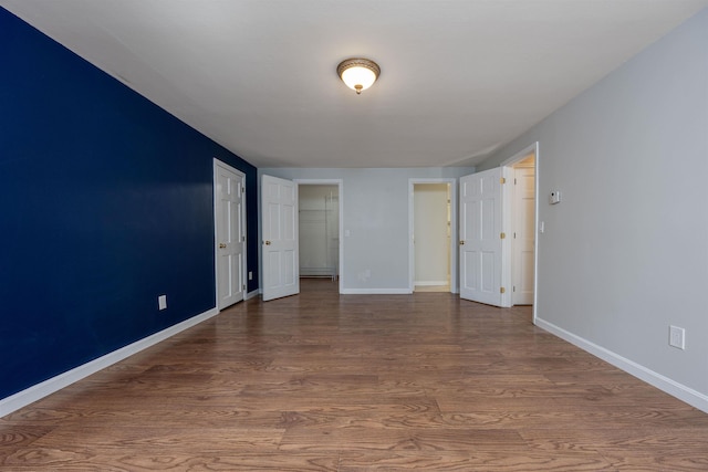 interior space featuring baseboards and wood finished floors