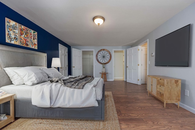 bedroom featuring baseboards and wood finished floors
