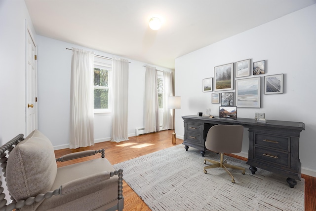 office space with baseboards and wood finished floors