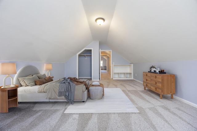 bedroom with baseboards, carpet, and lofted ceiling