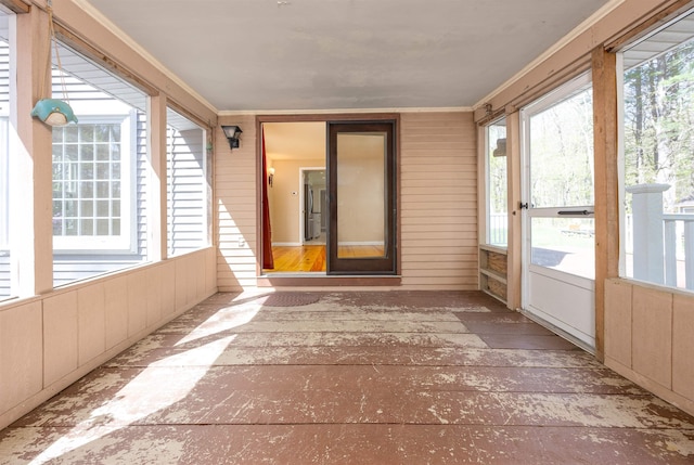unfurnished sunroom featuring crown molding