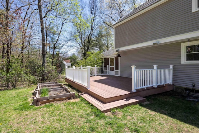 wooden terrace with a lawn and a garden