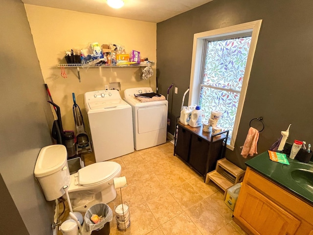 laundry room with independent washer and dryer, laundry area, and light tile patterned floors
