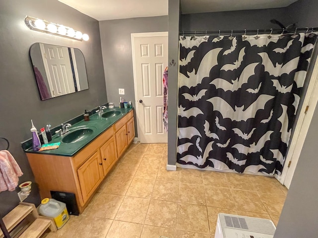 bathroom featuring double vanity, a shower with curtain, a sink, and tile patterned flooring