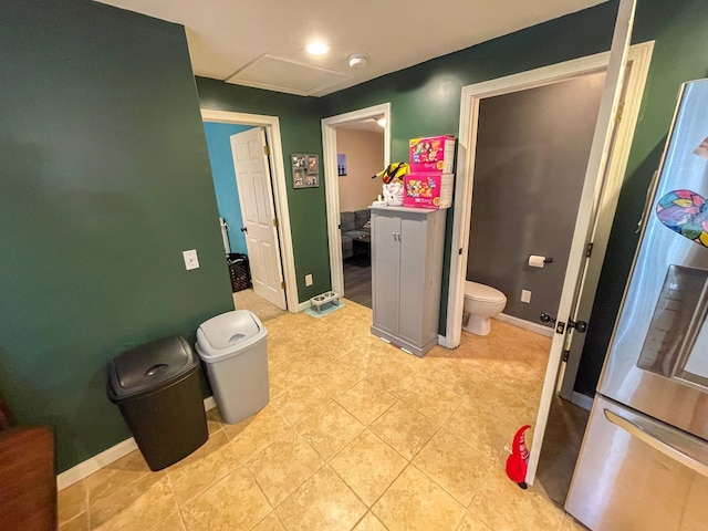 bathroom with toilet, tile patterned floors, and baseboards