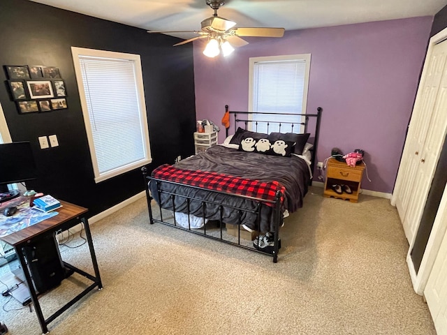 bedroom with a closet, a ceiling fan, carpet, and baseboards