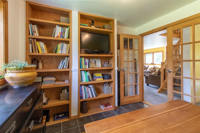 sitting room featuring dark tile patterned flooring and french doors