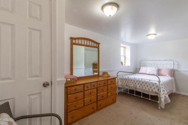 bedroom featuring light carpet