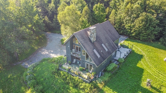 birds eye view of property with a view of trees