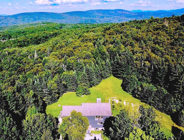drone / aerial view with a mountain view and a forest view