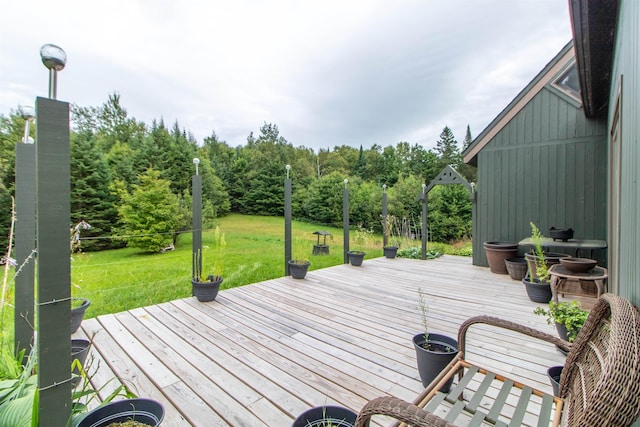 wooden terrace featuring a yard