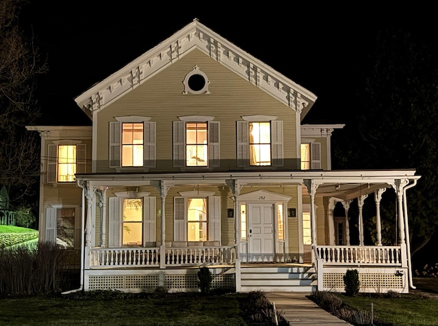 italianate home featuring covered porch