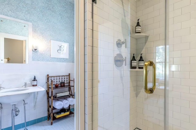 full bathroom featuring a stall shower and a wainscoted wall