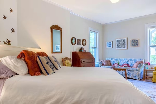 bedroom featuring ornamental molding and wood finished floors