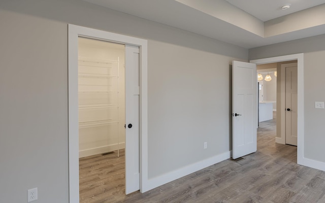 unfurnished bedroom featuring baseboards and wood finished floors