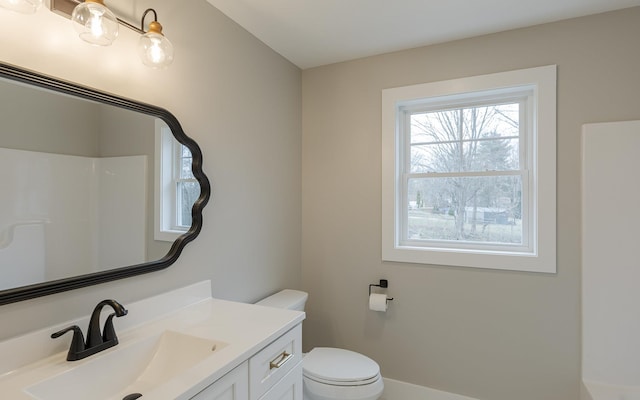 full bath featuring vanity, a shower, and toilet
