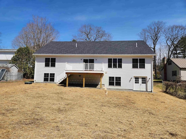 back of house with stairs, a lawn, and a wooden deck
