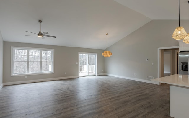 unfurnished living room featuring ceiling fan, visible vents, baseboards, high vaulted ceiling, and dark wood-style floors
