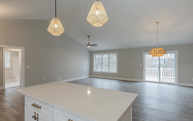 kitchen with visible vents, wood finished floors, open floor plan, light countertops, and white cabinetry