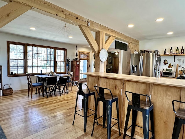 bar featuring recessed lighting, stainless steel fridge, and light wood-style flooring