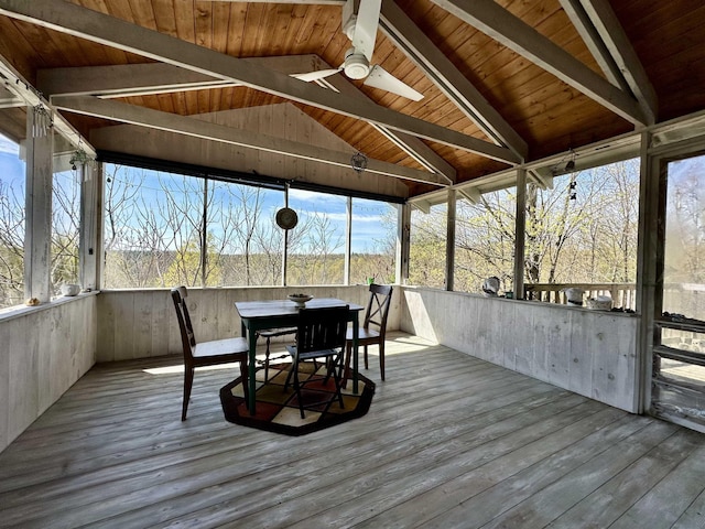 sunroom featuring ceiling fan, beamed ceiling, and outdoor dining area