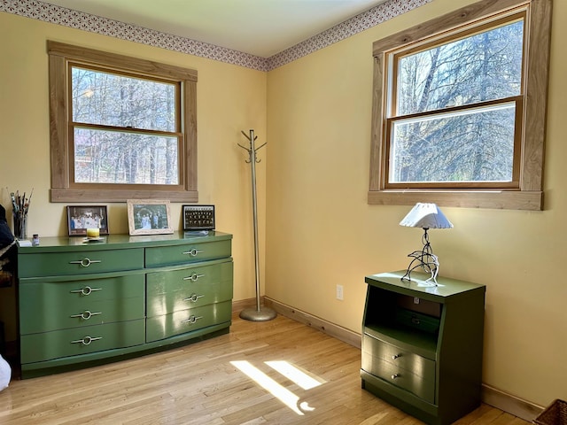 misc room with baseboards and light wood-type flooring