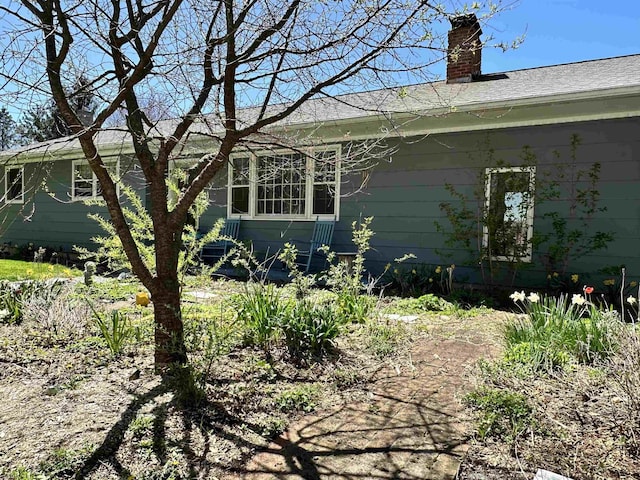 view of side of property featuring a chimney