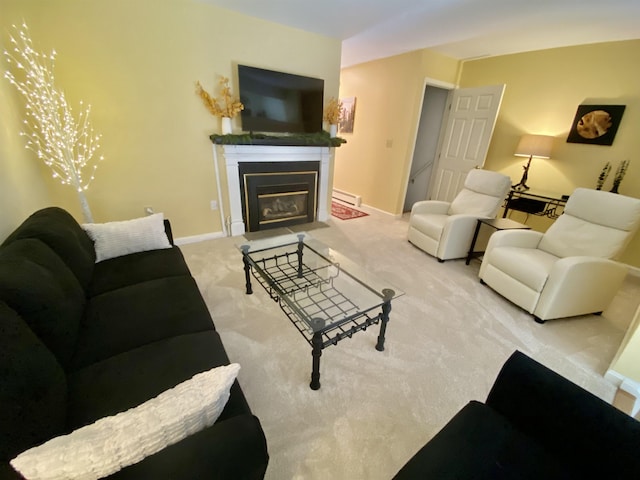 carpeted living area with baseboards, a fireplace with flush hearth, and a baseboard heating unit