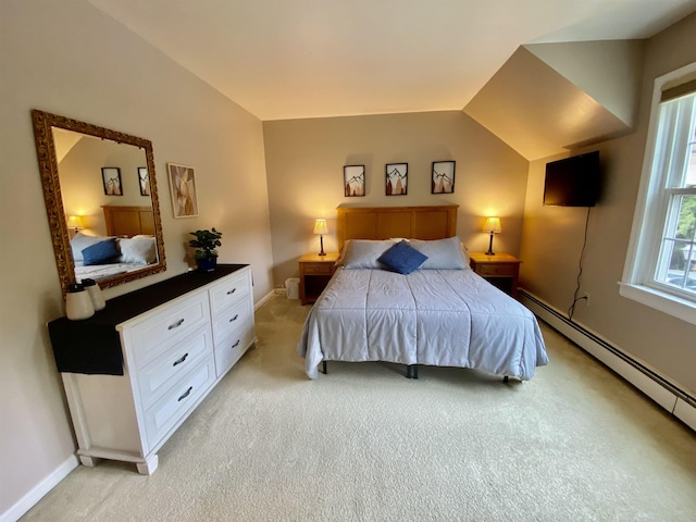 bedroom featuring light colored carpet, baseboards, a baseboard heating unit, and vaulted ceiling