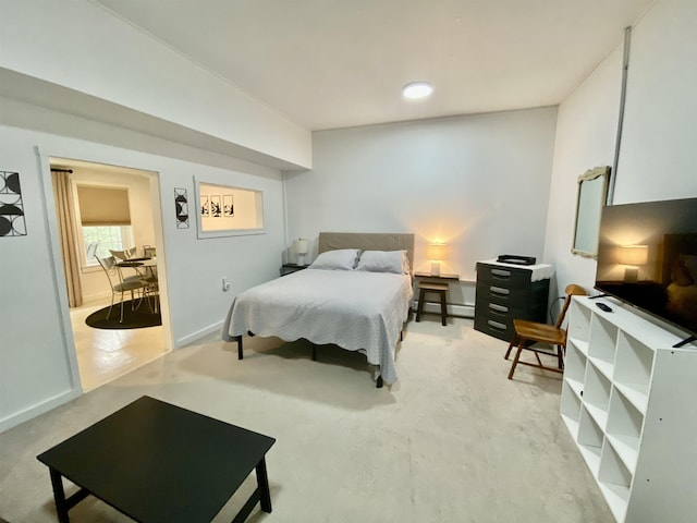bedroom featuring baseboards and light carpet