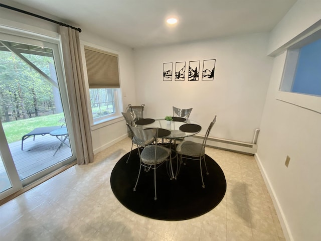 dining room with baseboards, a baseboard heating unit, and recessed lighting