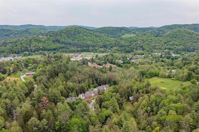 drone / aerial view featuring a view of trees and a mountain view