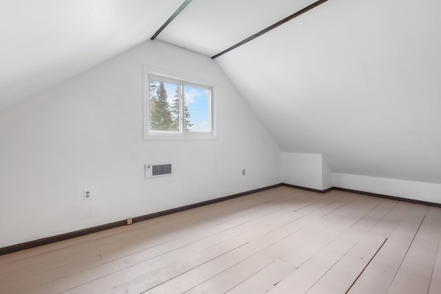 bonus room with baseboards, visible vents, wood finished floors, and lofted ceiling