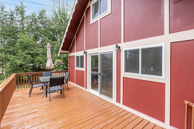 wooden terrace with outdoor dining space