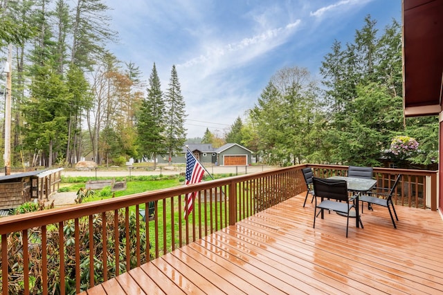 deck featuring a yard and outdoor dining area