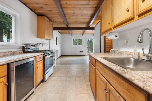 kitchen featuring a sink, gas stove, beverage cooler, wooden ceiling, and beamed ceiling