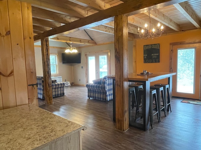 dining space with baseboards, dark wood-style flooring, a chandelier, and wooden ceiling