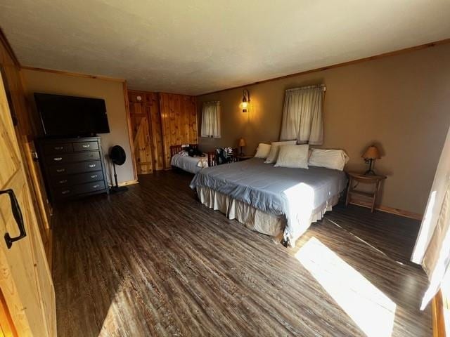 bedroom featuring baseboards and wood finished floors