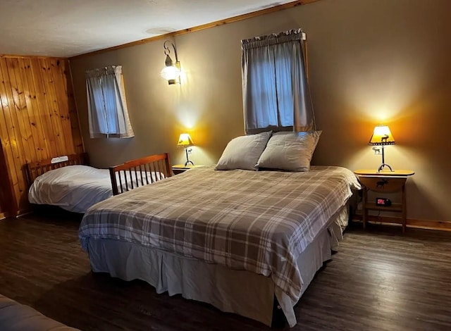 bedroom with baseboards and wood finished floors