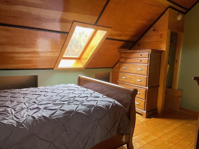 bedroom featuring vaulted ceiling and light wood finished floors