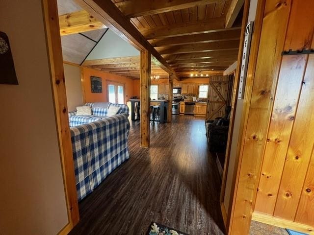 hallway with dark wood-style flooring, beamed ceiling, and wood ceiling
