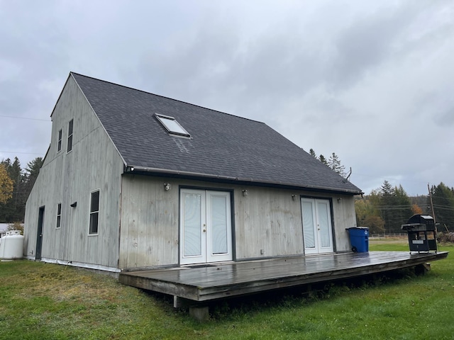 back of house with french doors, roof with shingles, a yard, and a deck