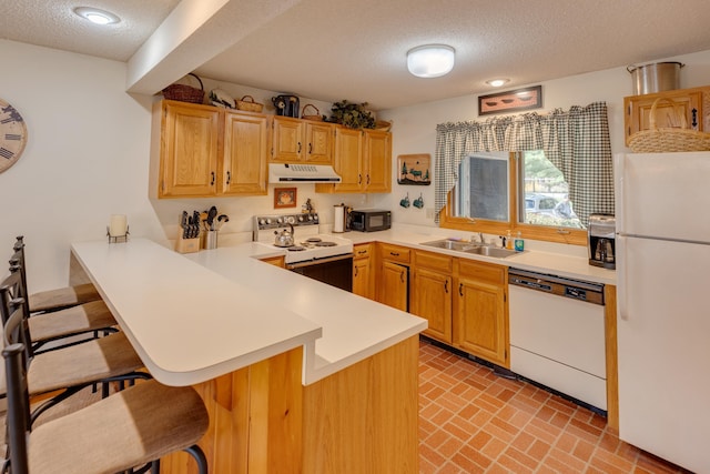 16 Riverfront Dr Unit 292, Woodstock, NH 03262 - kitchen featuring white appliances, a breakfast bar area, ventilation hood, a textured ceiling, and a sink