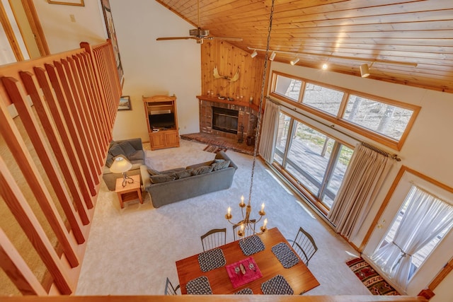 16 Riverfront Dr Unit 292, Woodstock, NH 03262 - carpeted living room with a brick fireplace, high vaulted ceiling, wooden ceiling, and ceiling fan with notable chandelier